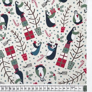 Fabric featuring a Christmas-themed pattern with penguins and holiday decorations.