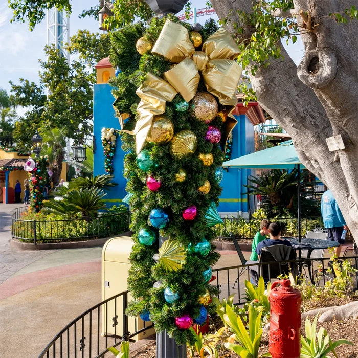 Decorative Christmas wreath with colorful ornaments in an outdoor setting