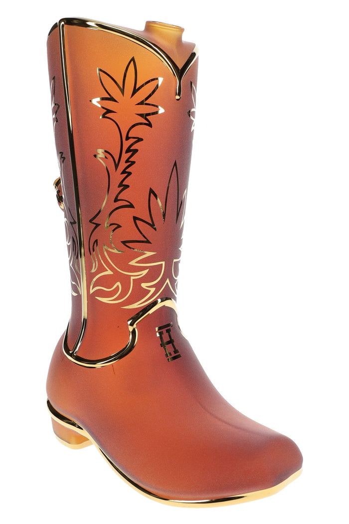 Frosted amber Hemper Wild West cowboy boot glass bong with gold trim and leaf etching, angled studio shot showing top mouthpiece and toe detail.