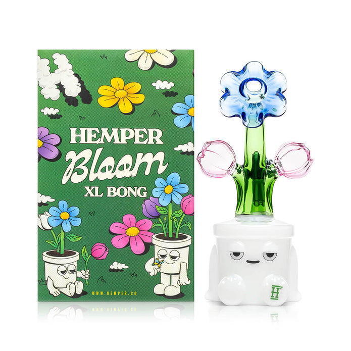 Hemper Bloom XL Bong box next to flower-top glass bong, blue bloom mouthpiece and white base with face detail