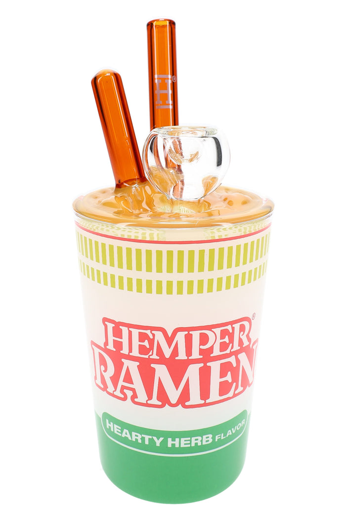 7-inch Hemper ramen cup glass bong with yellow noodle lid, clear bowl and amber chopstick mouthpieces on white.