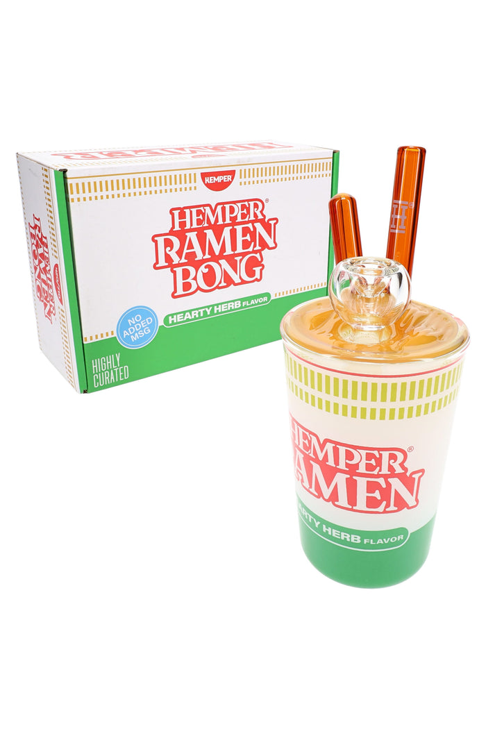 Hemper ramen cup themed glass bong posed before matching retail box with instant noodle styling and amber chopsticks.