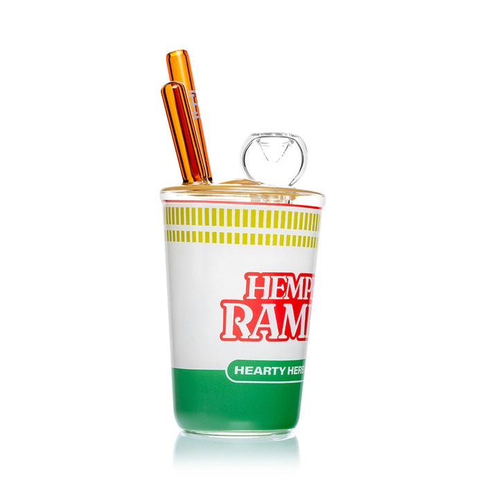 Side view of Hemper ramen cup glass water pipe with clear cup body, yellow ramen lid and tall amber mouthpiece.